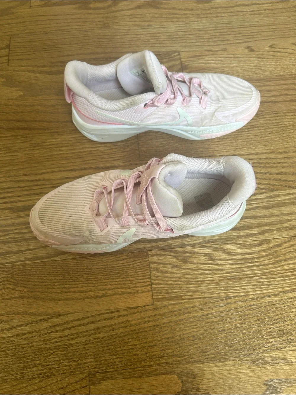 Kids Light Pink Nike Athletic Sneakers with White Swoosh